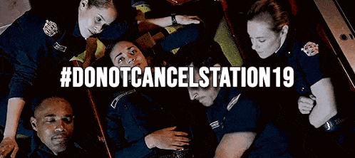 a group of police officers are laying on top of each other on the floor .