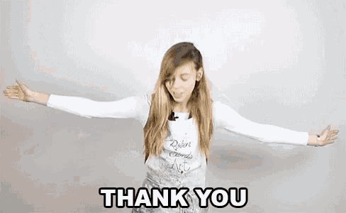 a young woman is standing with her arms outstretched and says `` thank you very much '' .