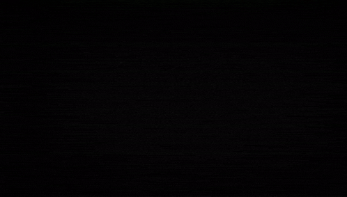 a girl with long white hair stands in a dark room