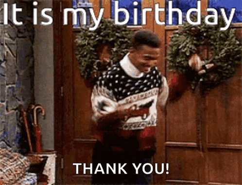a man in a sweater is standing in front of a door holding a gun and says it is my birthday thank you .