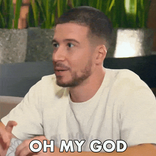 a man with a beard says oh my god in a white shirt