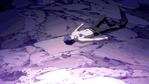a shirtless man is laying on the ground