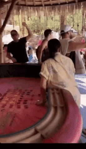 a group of people standing around a table with a sign that says ' hawaii '