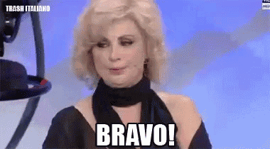 a woman in a black dress and scarf says bravo !
