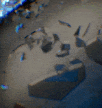 a blurred image of a few pieces of broken glass on the ground