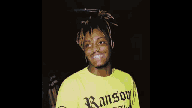 a man with dreadlocks is wearing a white shirt that says archiv