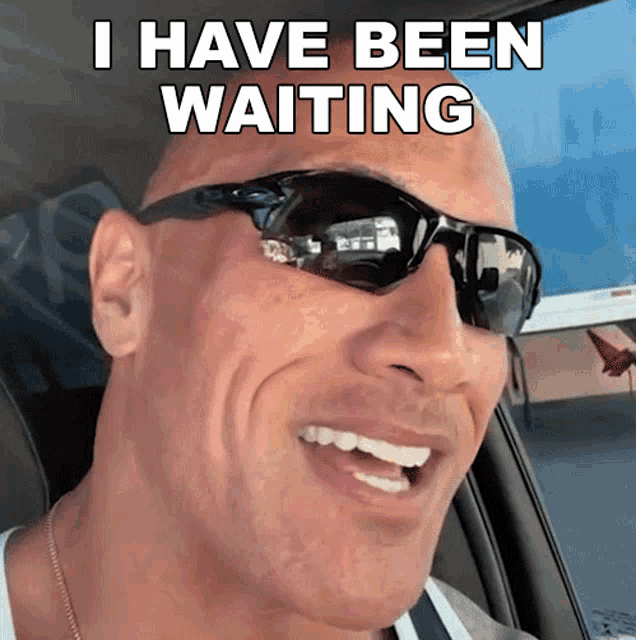 a man wearing sunglasses says " i have been waiting " while sitting in a car