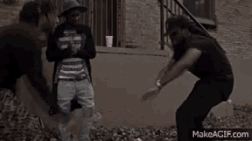 two people are standing next to each other on the sidewalk .