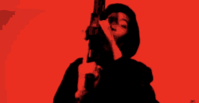 a silhouette of a man standing in front of a red wall