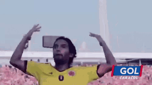 a man in a yellow jersey with the number 0 on it is dancing
