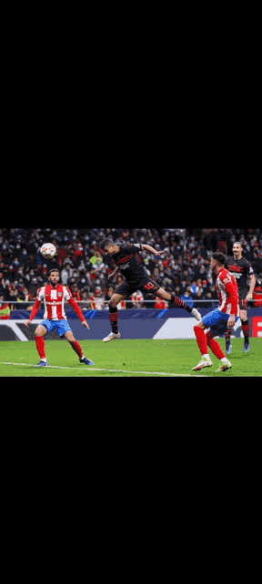 a soccer player is jumping in the air to head the ball during a game
