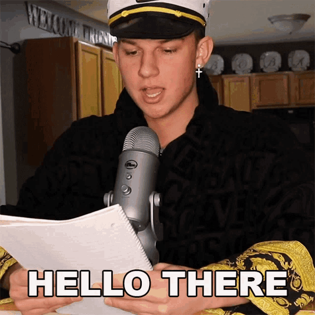 a man in a captain 's hat reads a piece of paper with the words hello there written on it