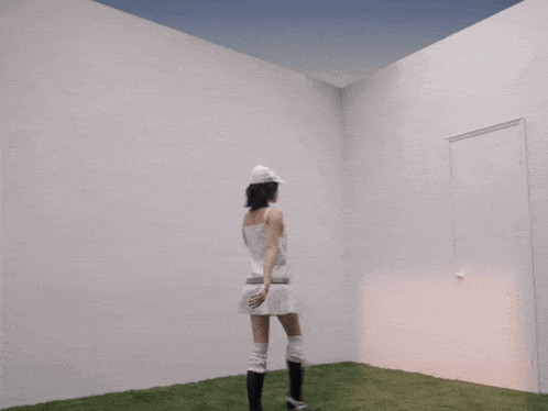 three women in white dresses are standing in front of a white door
