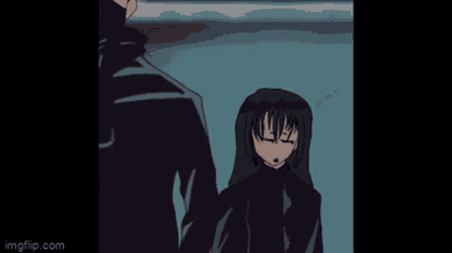 a man and a woman are standing next to each other and the woman is raising her fist in the air .