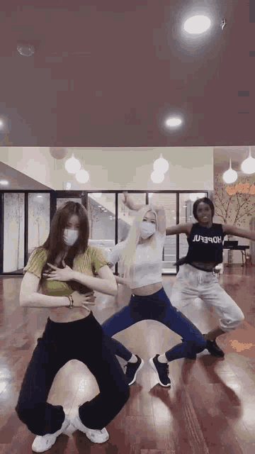 a group of young women are dancing in a dance studio with one wearing a shirt that says homer on it