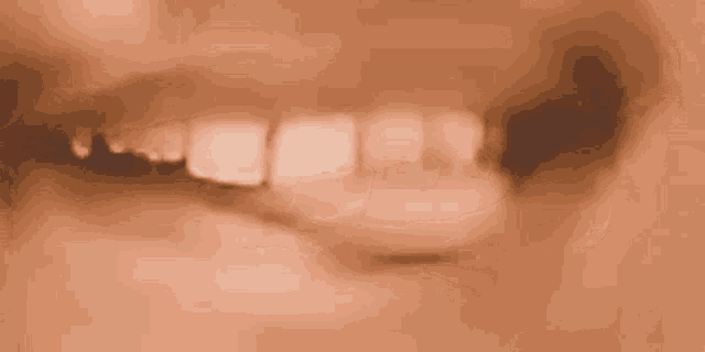 a close up of a woman 's mouth with her tongue sticking out .