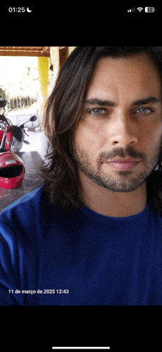 a picture of a man with long hair and a beard taken on march 11