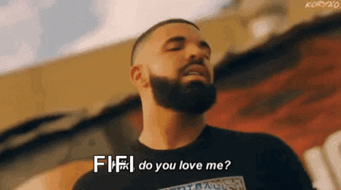 a man with a beard is standing in front of a building and saying `` fifi do you love me '' .