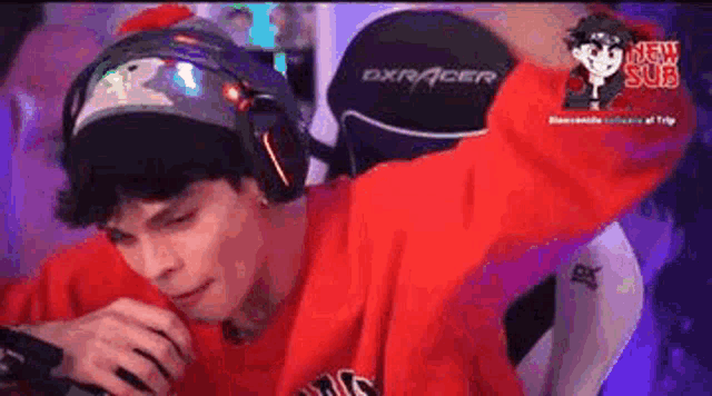 a man wearing headphones is sitting in a gaming chair .
