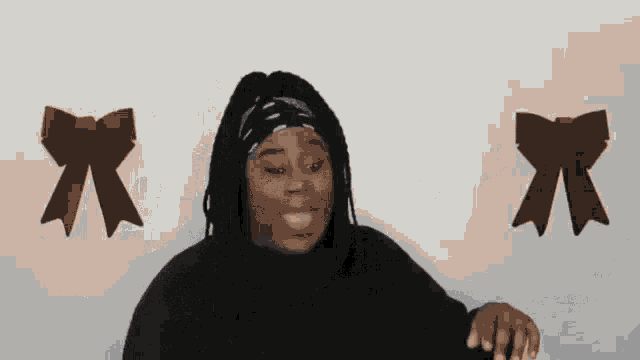 a woman wearing a headband is standing in front of two brown bows