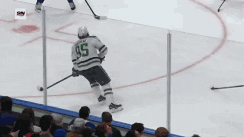 a hockey game is being played in front of a medals sign
