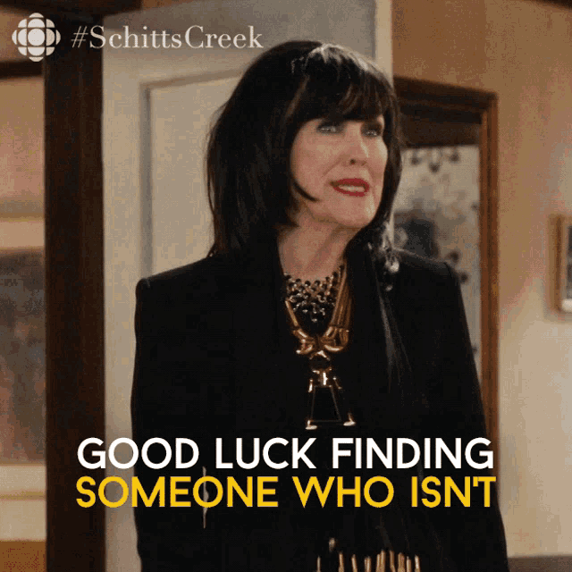 a poster for schitts creek shows a woman in a black suit