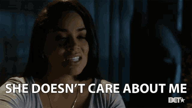 a woman says " she does n't care about me " in a dark room