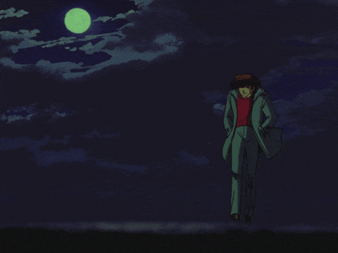 a man in a red shirt and a green coat stands in the dark under a full moon