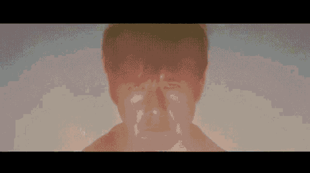 a close up of a man 's face with a light shining on it