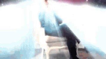 a man in a suit is standing in a cloud of smoke and talking on a cell phone .