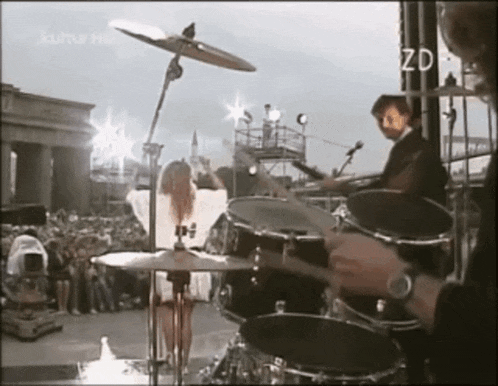 a man is playing drums in front of a crowd and the words kultur hd are on the bottom