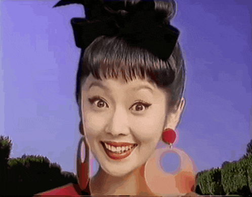 a woman with a bow in her hair is smiling