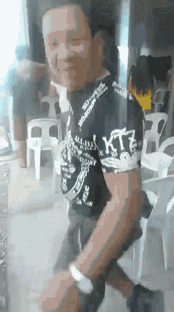 a man wearing a black shirt that says ktz
