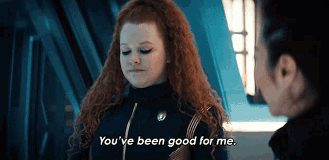 a woman with red hair is talking to another woman and says you 've been good for me