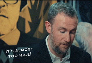 a man says it 's almost too nice in front of a painting of a man