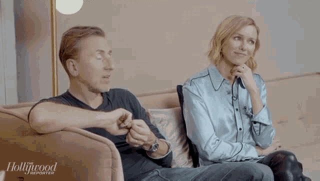 a man and woman are sitting on a couch with the hollywood reporter written on the bottom of the screen