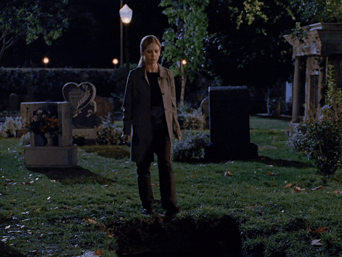 a grave in a cemetery has a heart shaped gravestone