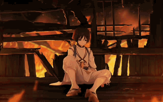 a girl sitting in front of a burning building with a fire in the background