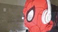 a person wearing a spiderman mask and headphones .