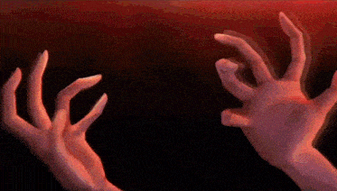 a person 's hands are reaching out in a dark room .