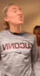 a woman wearing a nike shirt is standing in front of a man .