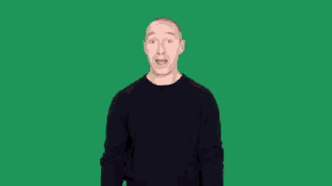 a man in a black shirt is giving a thumbs up