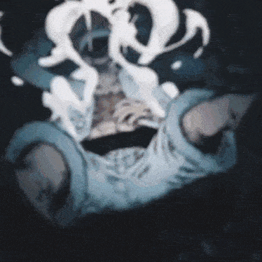a blurry picture of a person with smoke coming out of their mouth .