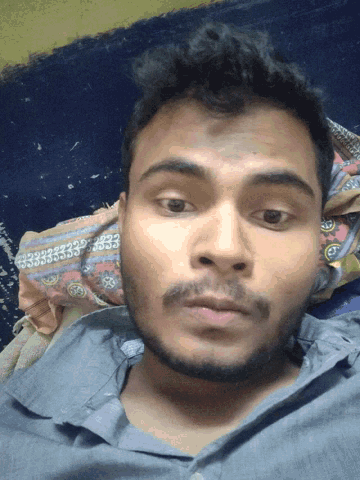 a man with a beard is laying on a bed with a pillow that says 3333 on it