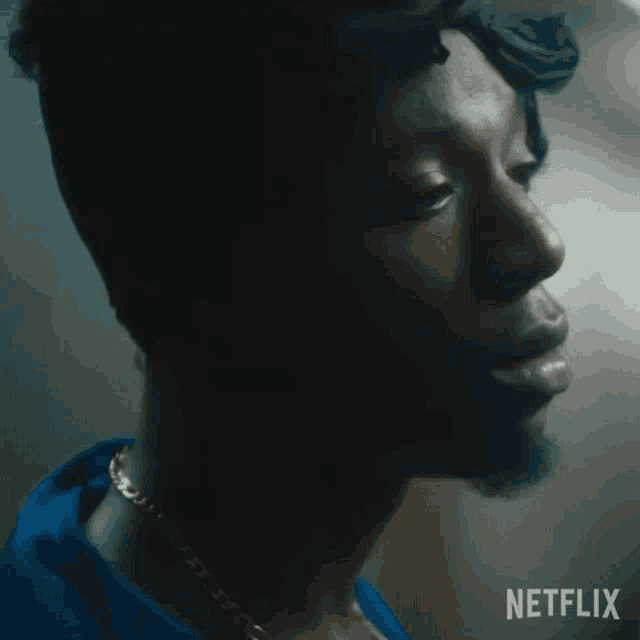 a close up of a man 's face in a dark room with a netflix logo in the corner .