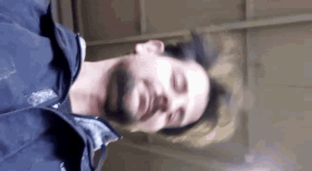a man with a beard is making a funny face