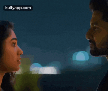 a man and a woman are looking at each other with their eyes closed .