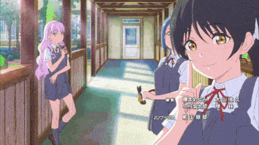 a group of anime girls standing in a hallway with chinese writing on the bottom right