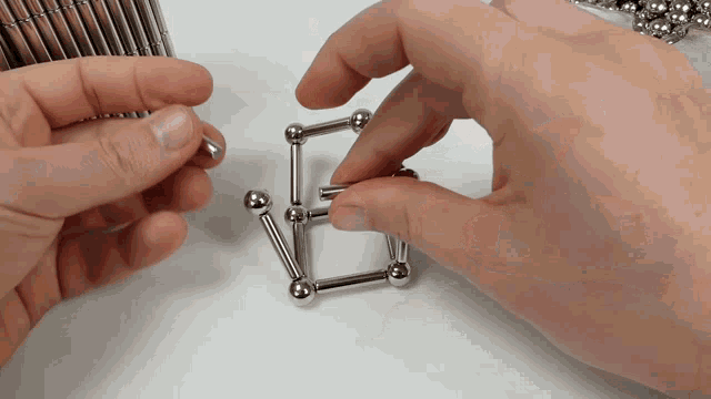 a person is playing with a set of magnetic balls and rods
