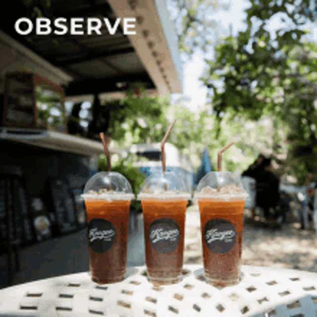 three cups of coffee with straws on a table with the words observe above them